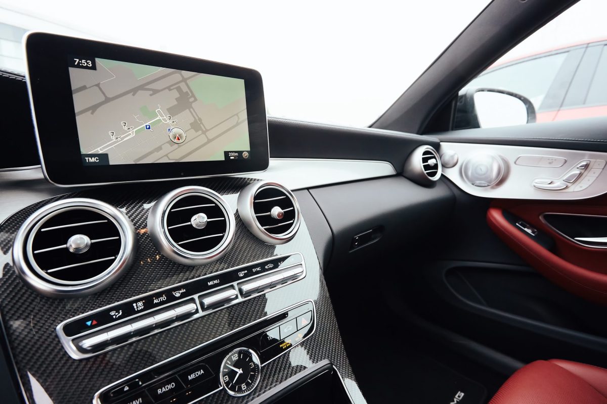 Car dashboard with a GPS navigation unit showing a map