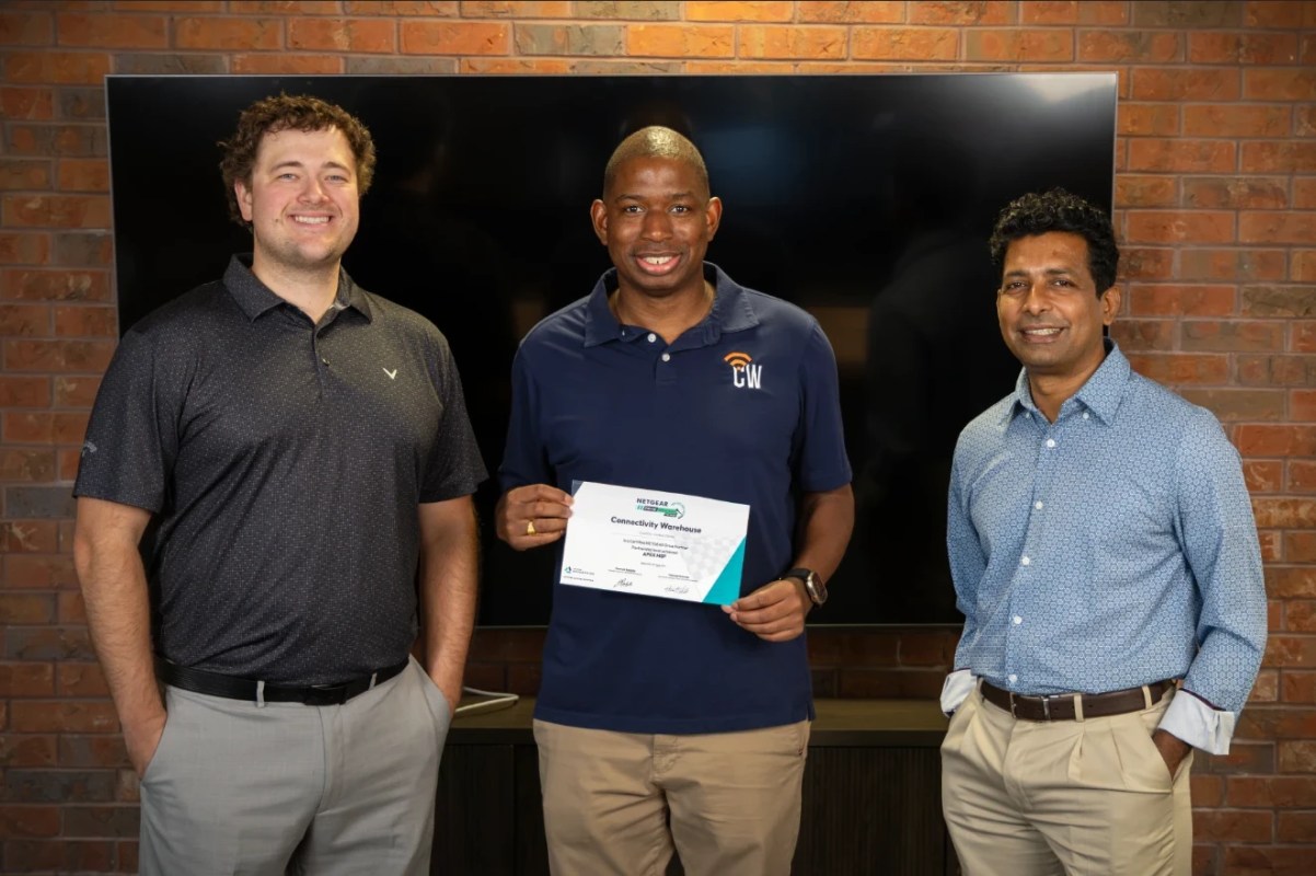 From left: Jacob Turner of NETGEAR, Steve Cox of Connectivity Warehouse holding the NETGEAR DRIVE APEX MSP partner certificate, and Sudarsan Vasudevan of NETGEAR