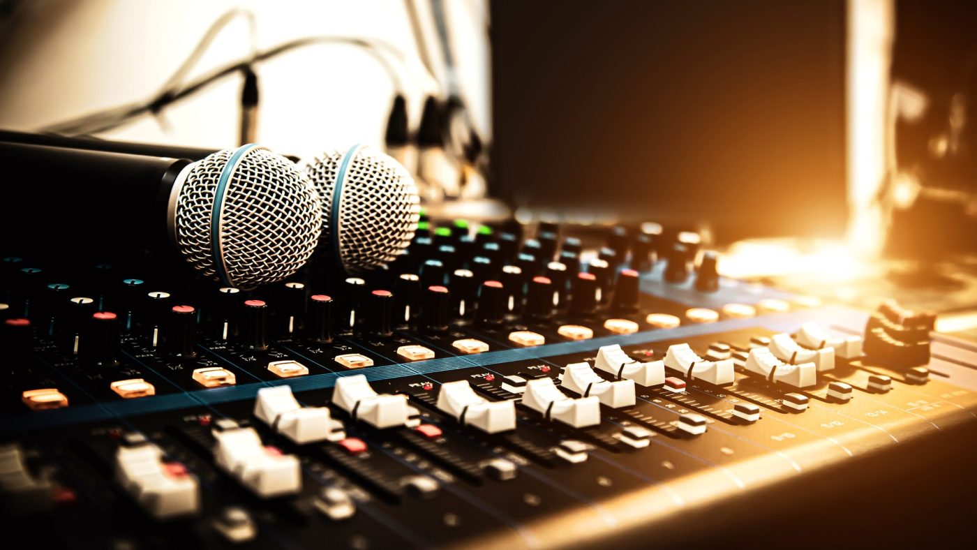 Microphones resting on a sound mixer in a recording studio